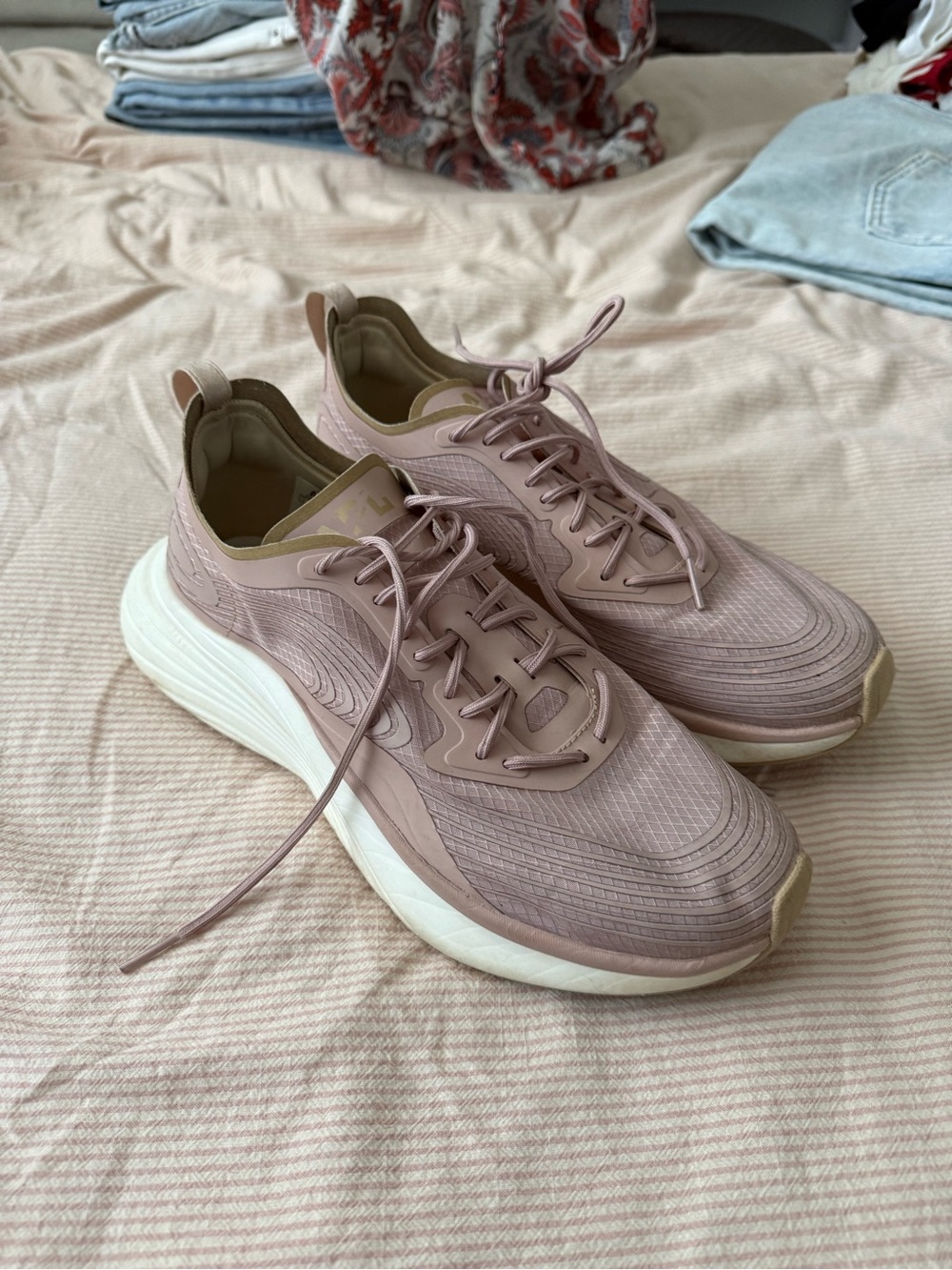 Women’s APL running shoe in a dusty rose color